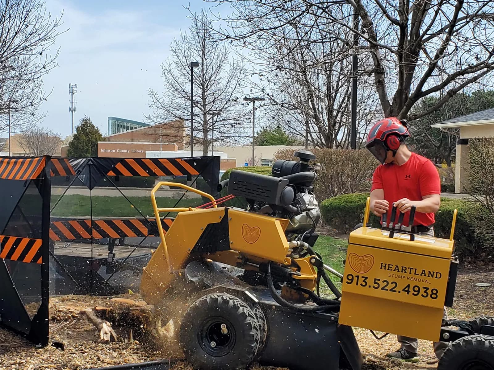 Matt operating Heartland’s stump grinder behind protective screens